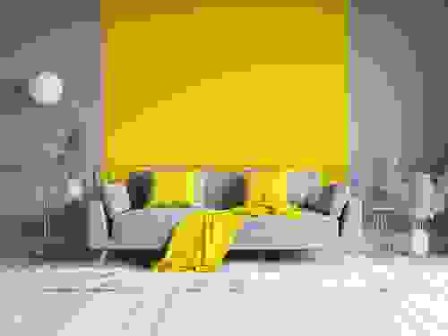 Pareti gialle per il soggiorno - divano grigio